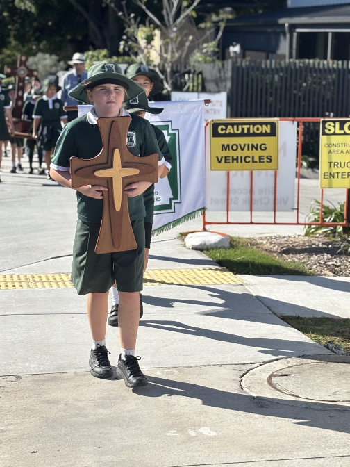 A student on pilgrimage walking with a sacred symbol