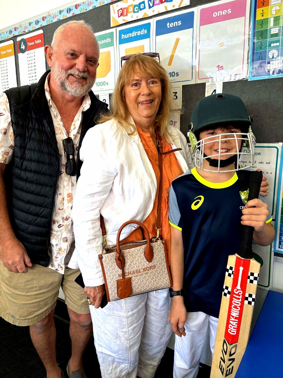 Holy Cross student shares classroom learning with grandparents during Grandparents' Day, highlighting family engagement and school community connections.